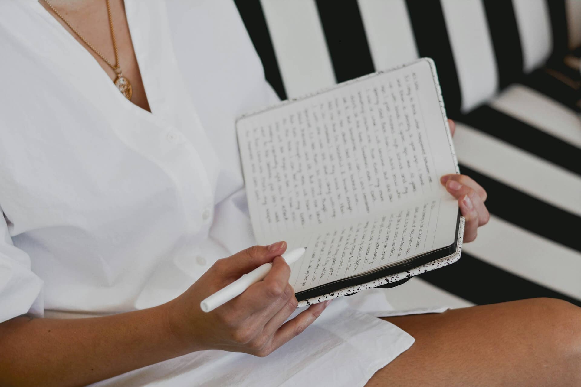 Person writing in a journal as part of a habit-building routine