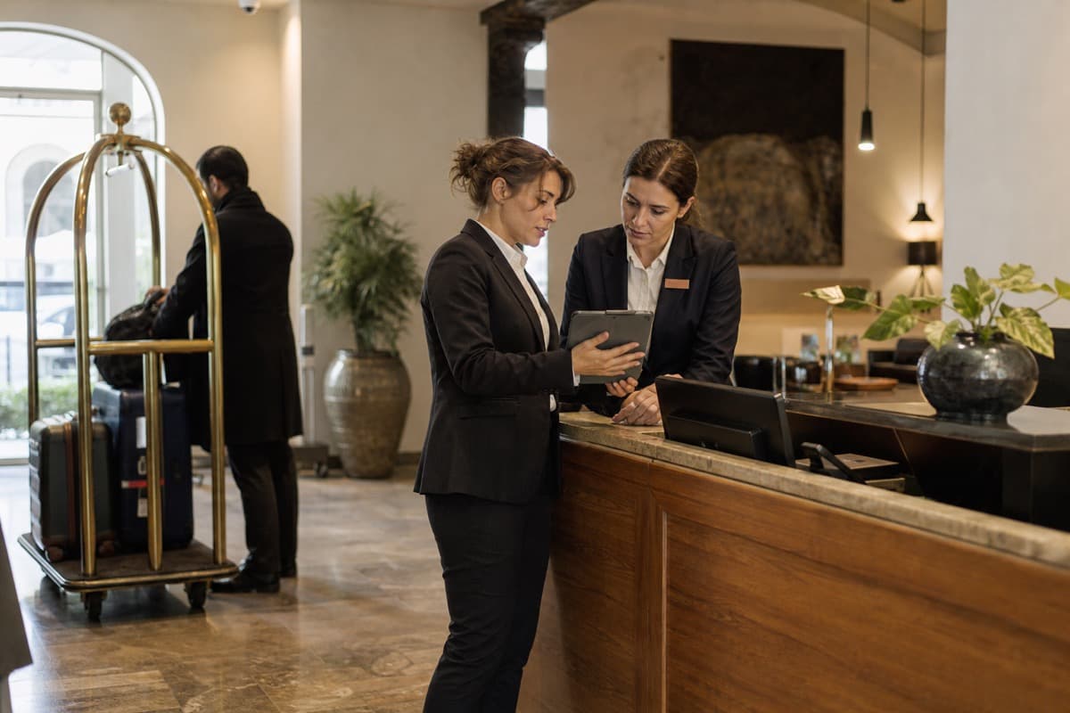 Hotel staff coordinating guest operations with a tablet