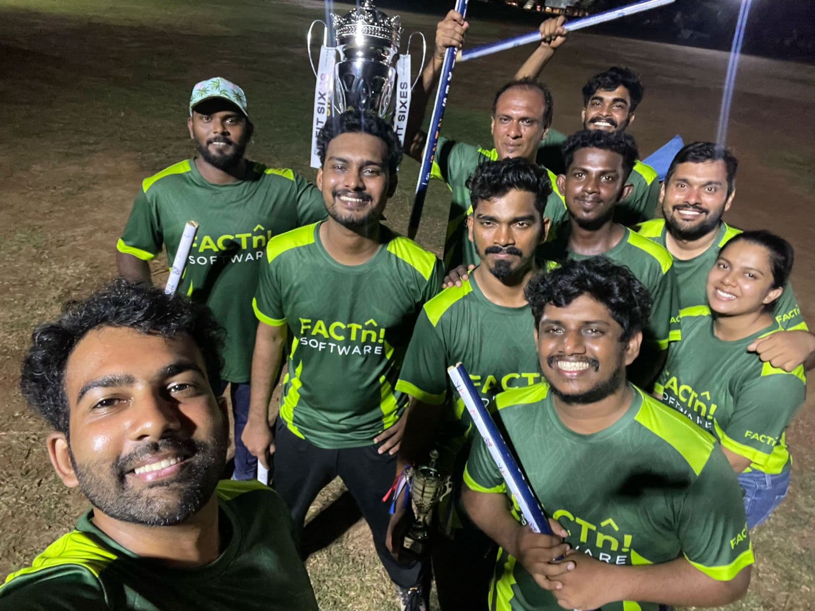 FACTn cricket team celebrating with the Fit Sixes trophy