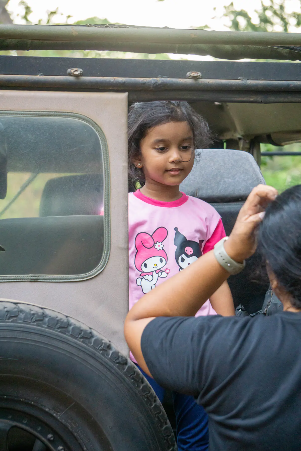 A child enjoying the ride from the back of a safari jeep