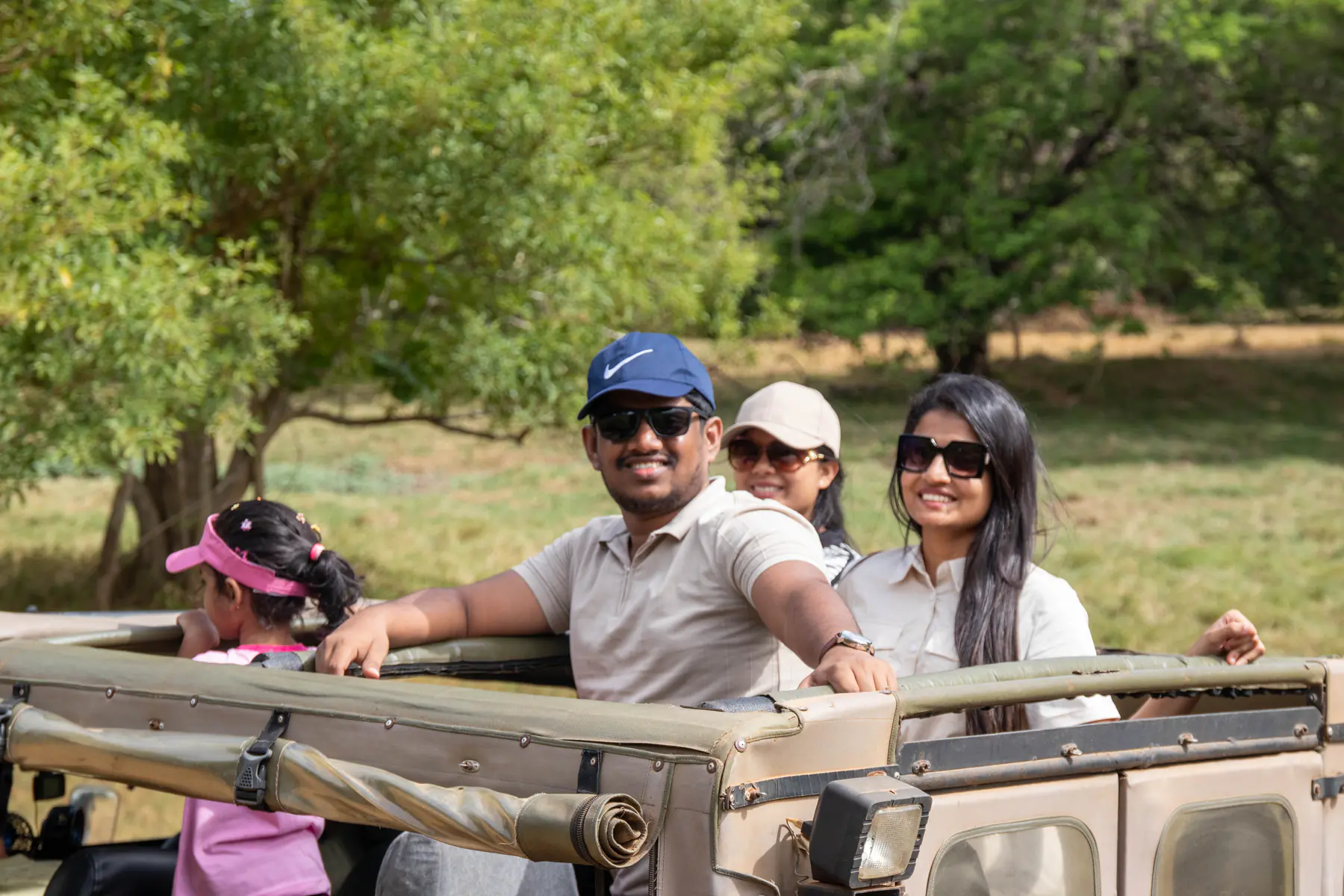 Two guests riding together in an open-top safari jeep at Minneriya