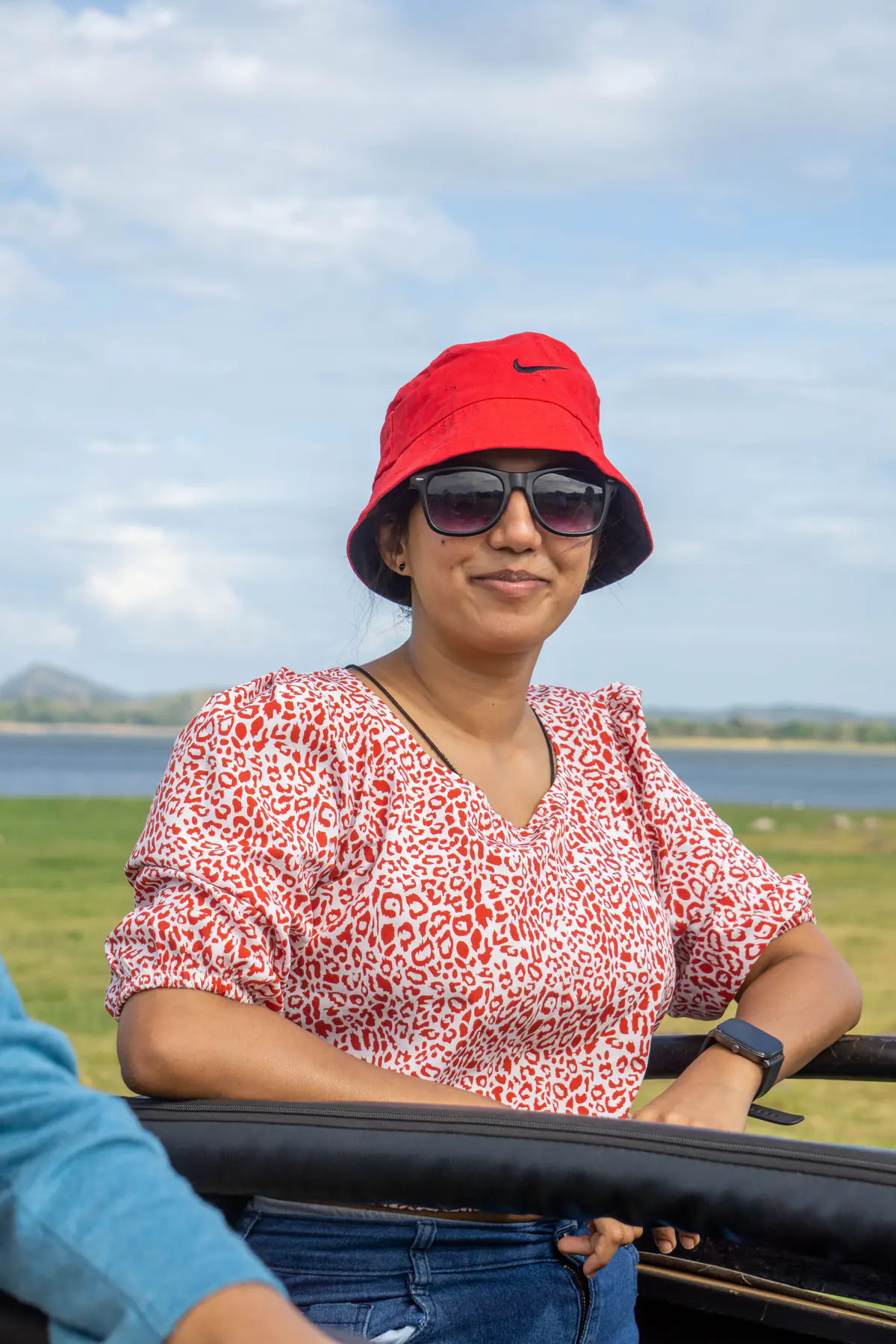 A guest in a red sunhat enjoying the Minneriya safari