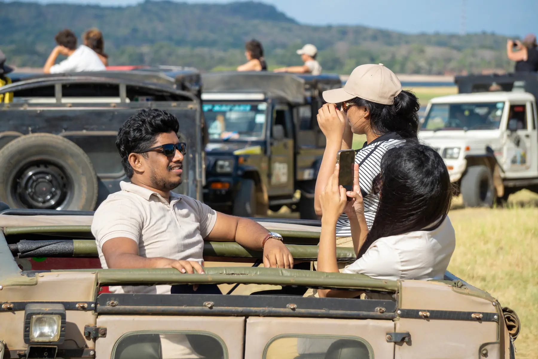 FACTn teammates chatting from open-top safari jeeps at Minneriya