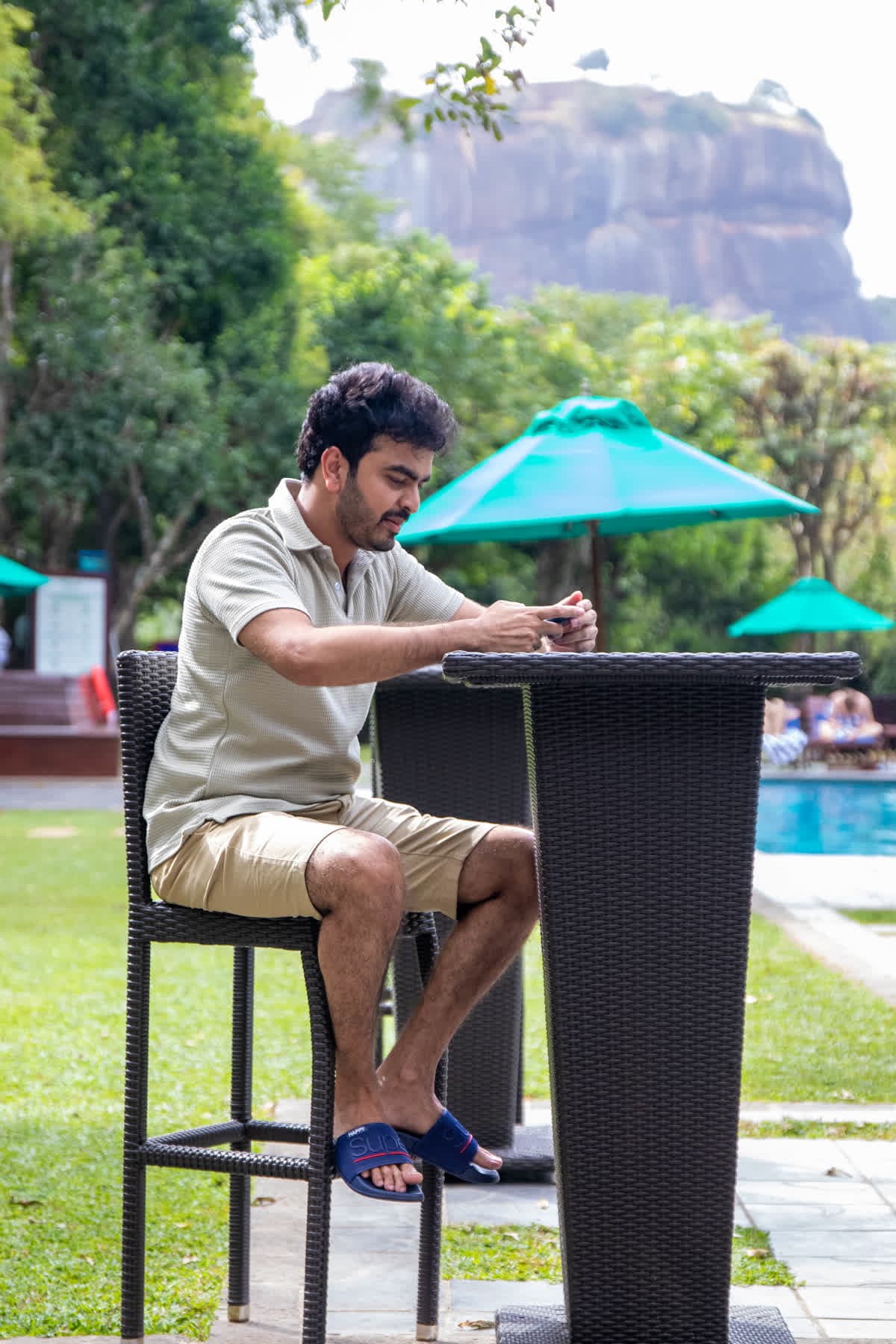 FACTn colleague taking part in an outdoor activity with Sigiriya Rock behind him