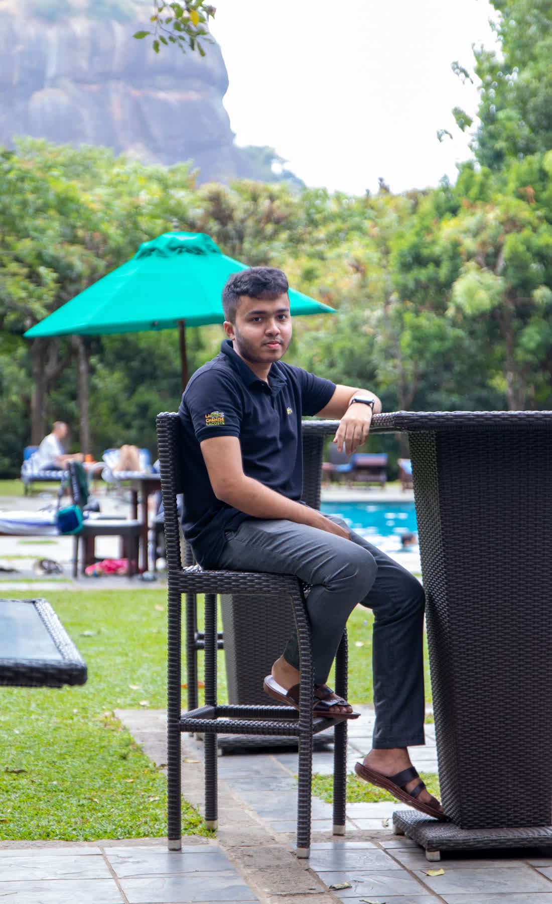 FACTn colleague seated outdoors with a view of Sigiriya Rock