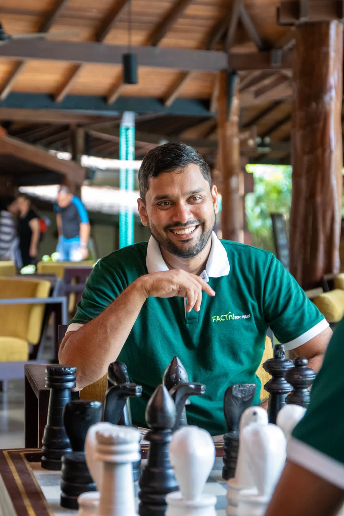 FACTn colleague smiling during a chess game at Hotel Sigiriya