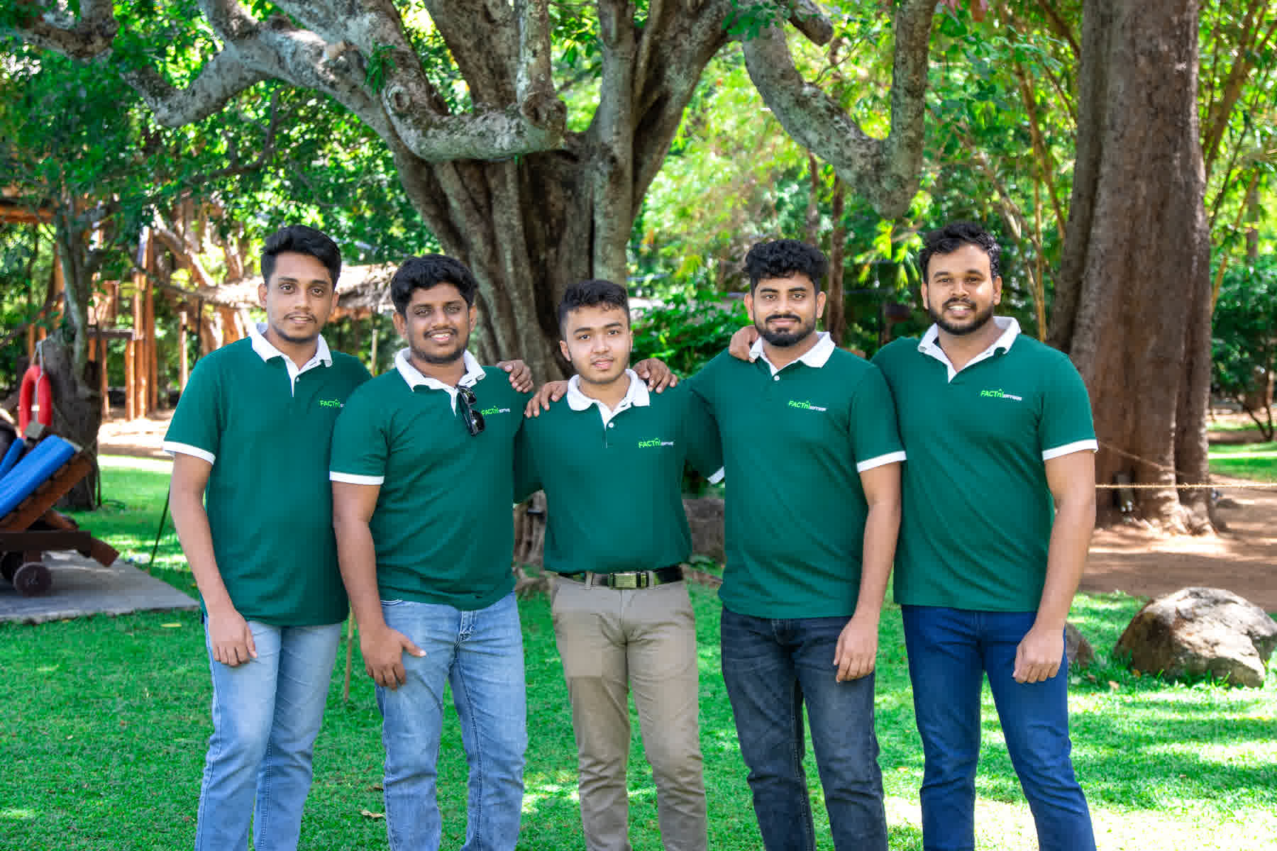 FACTn colleagues posing together beneath the trees at Hotel Sigiriya