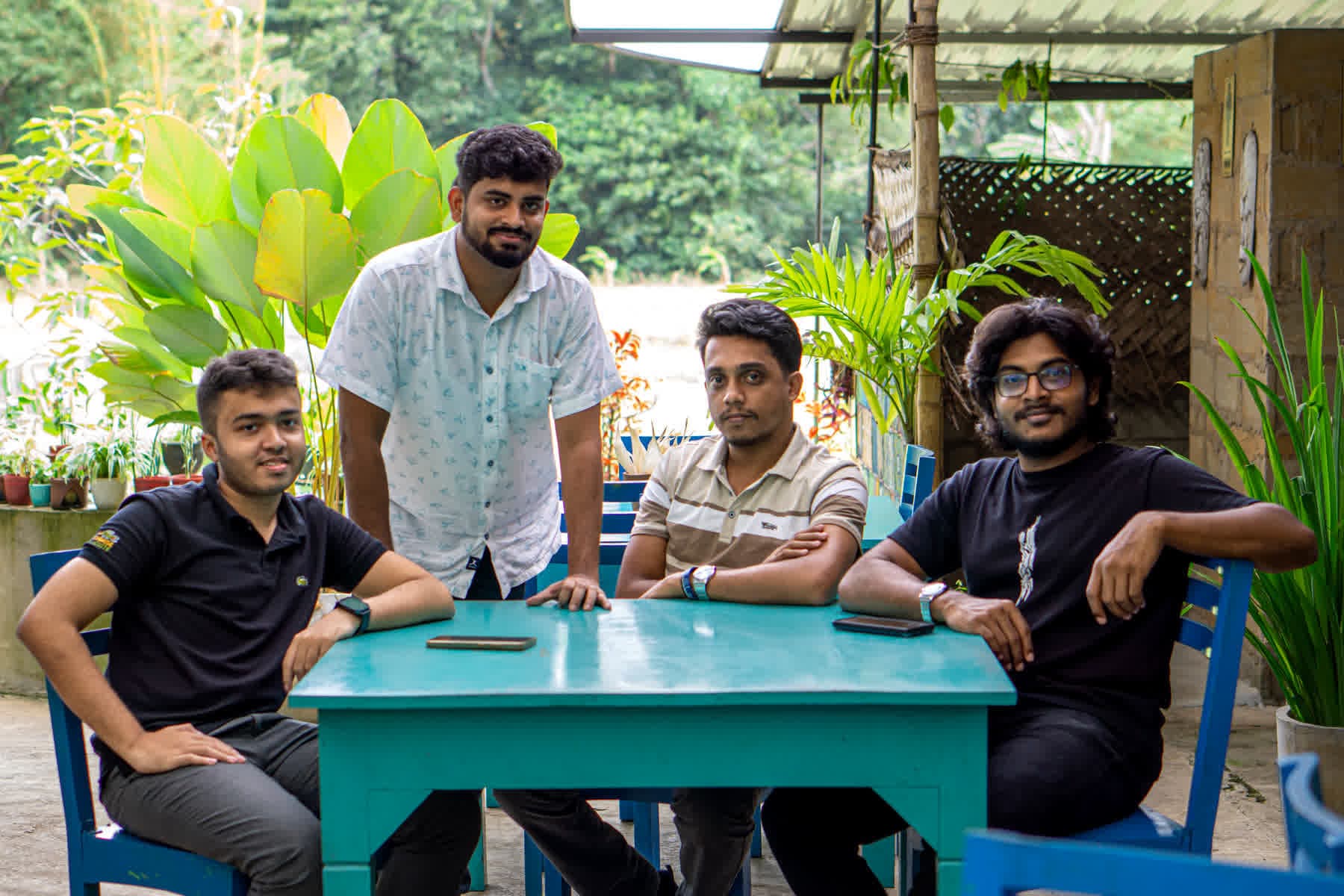 Five FACTn colleagues gathered around an outdoor table at Hotel Sigiriya
