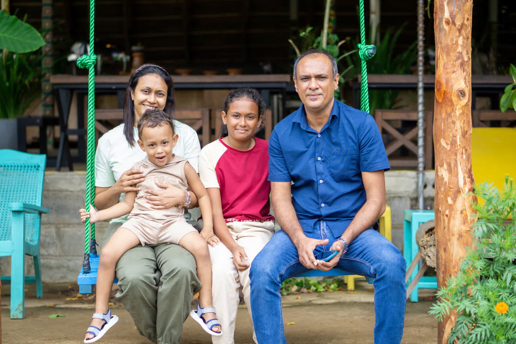 A family with a baby posing together at Hotel Sigiriya