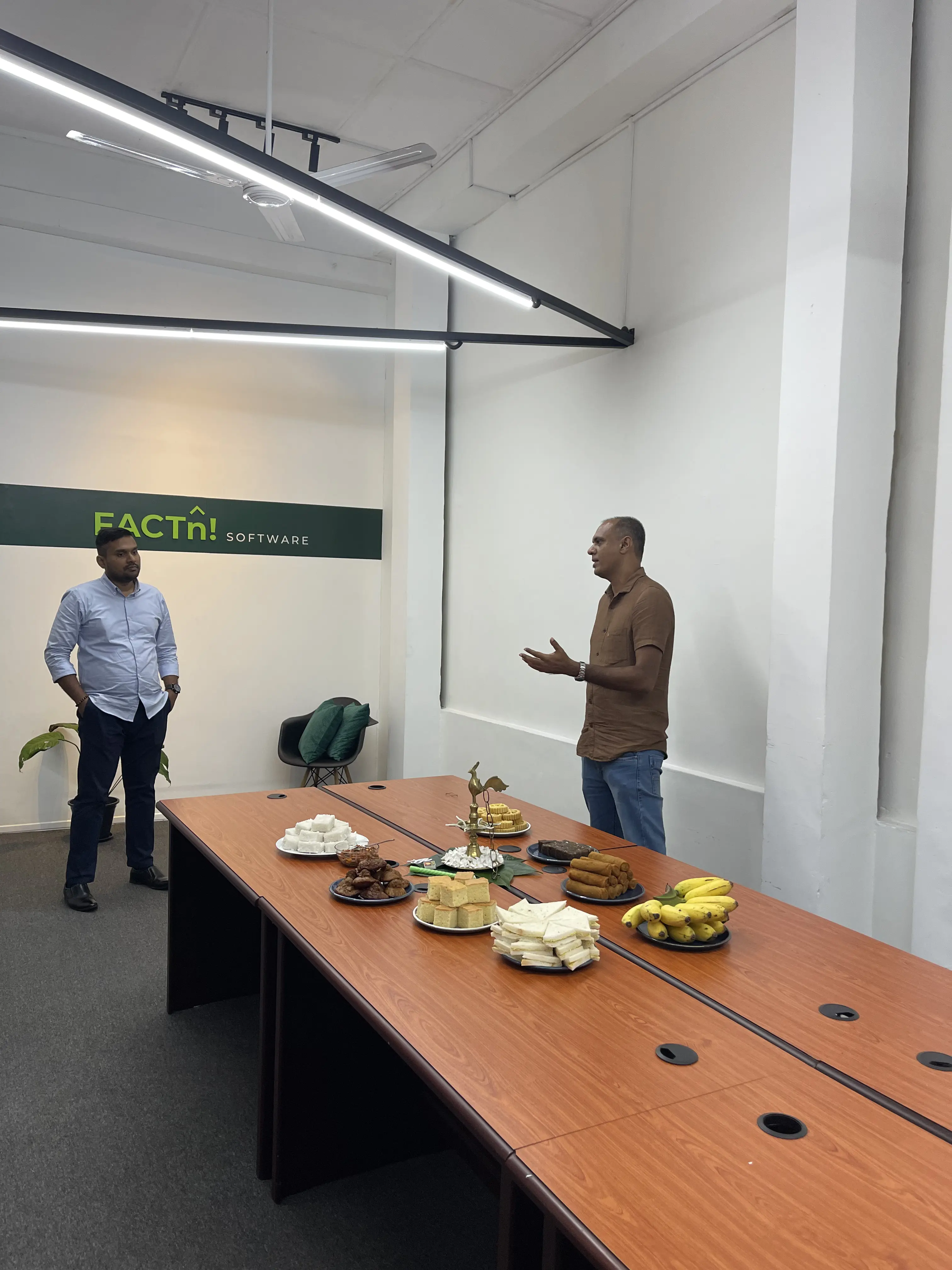 FACTn leaders speaking with the team in the office