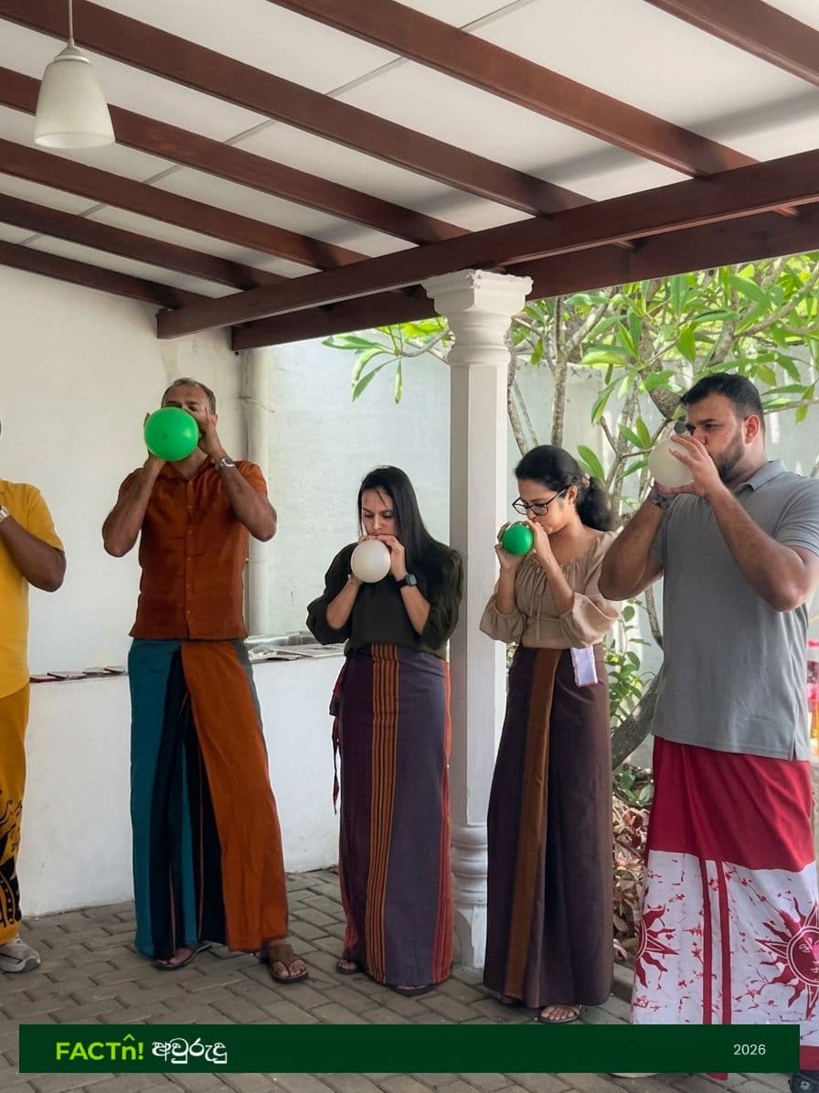 FACTn team members competing in a balloon-blowing Avurudu game