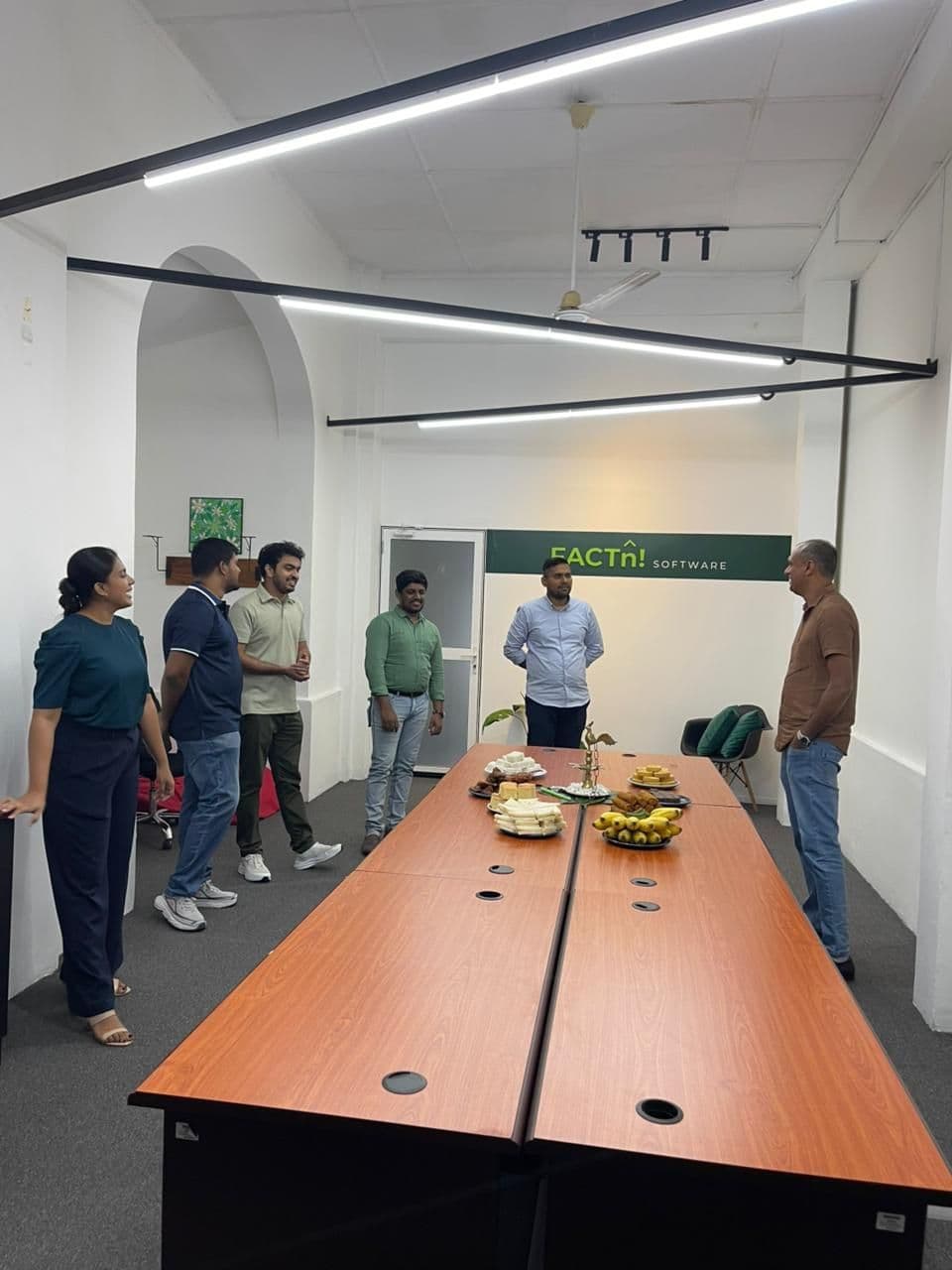 FACTn team gathered around the meeting table for the first day of 2026 celebration