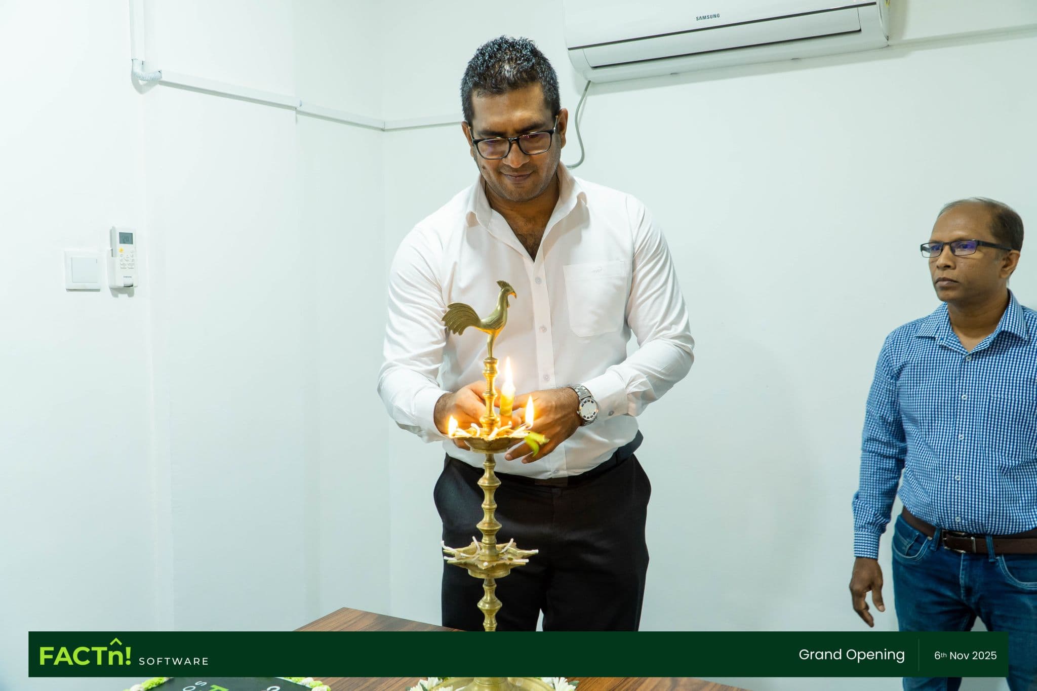 A guest lighting the ceremonial oil lamp at the FACTn office opening