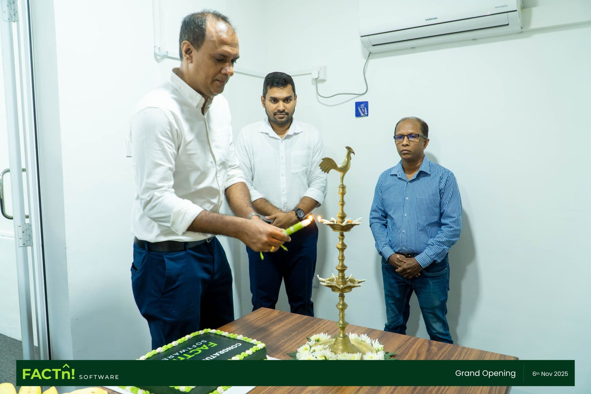 FACTn team lighting the traditional oil lamp at the new office opening